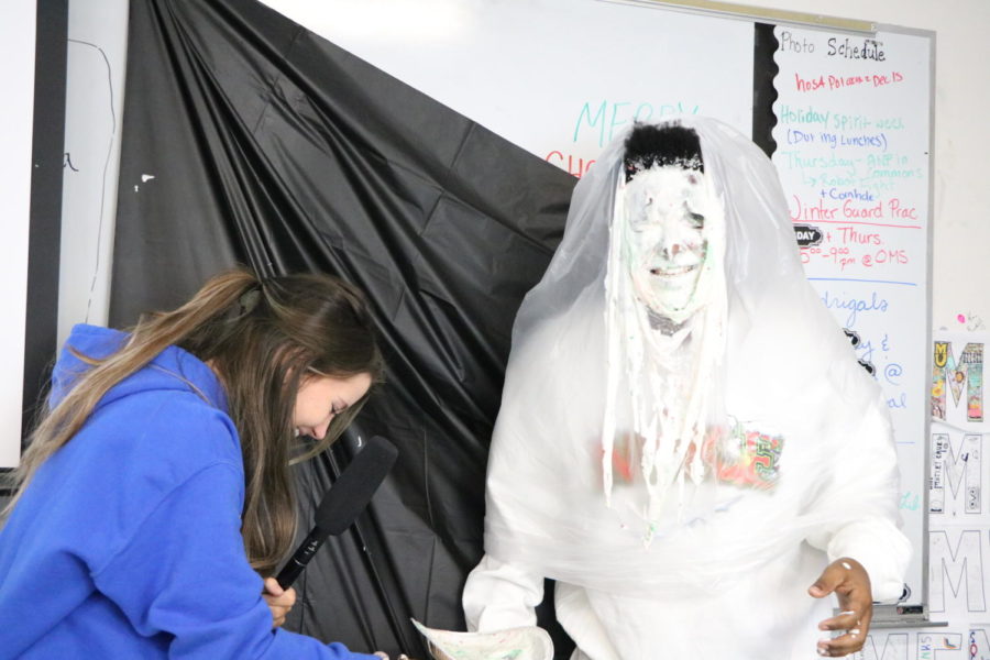 Aman Lueker (12) gets pied by Belma Mujakic (12) for the journalism fundraiser. 
“[Fundraisers should] make sure each one of them has a fun method,” Lueker said. Lueker was voted to be pied in the face on the OHS journalism Instagram account Tigerjournalism. 