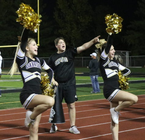 Jillian Woods (11) and Alexa Hallsten (11) cheer at a football game. “I have been working on my tumbling a lot… so I have better standing tumbling this year,” Hallsten said. As one of the team members who is able to do tumbling, Hallsten achieved a standing back tuck. 