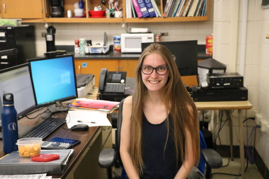 Darby ODonnell poses for a photo at her desk. “Y’all are great. I really like being here every day, ODonnell said. She attends Webster University and graduates this semester. 