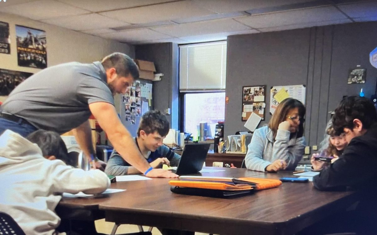 Kyle Bryant, SSD teacher, works with his students during class. ...You build a good connection with the kids, Bryant said, and they enjoy the little stuff, and its just enjoyable. Bryant has also coached football and wrestling during his eight years working at OHS.