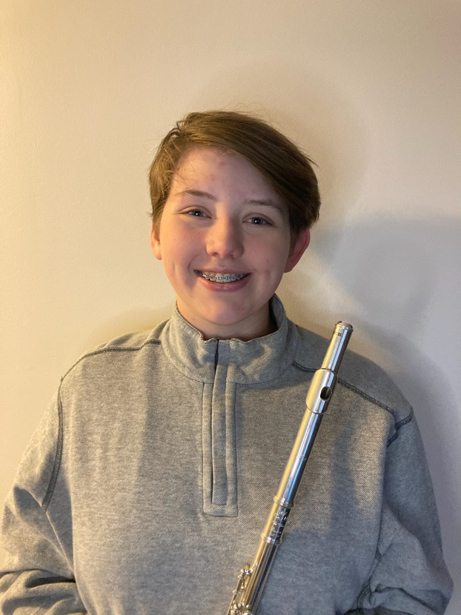 Ella Dinehart (9) poses with her flute. She is the only freshman in Wind Symphony. “...I feel like I have really high expectations to look up to since Im the only freshman. I just feel like he (Brakefield) expects a lot from me,” Dinehart said.