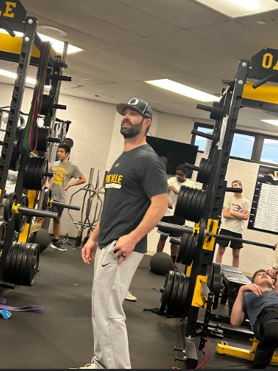 OHS coach Adam Williams supervises wrestlers in the weight room.  ...[I cant spend a lot of time with my family while coaching because with] practice you are usually here till 5 o’clock anyway, and during the winter it gets dark around 5:30, Williams said. Williams coaches wrestling and football.