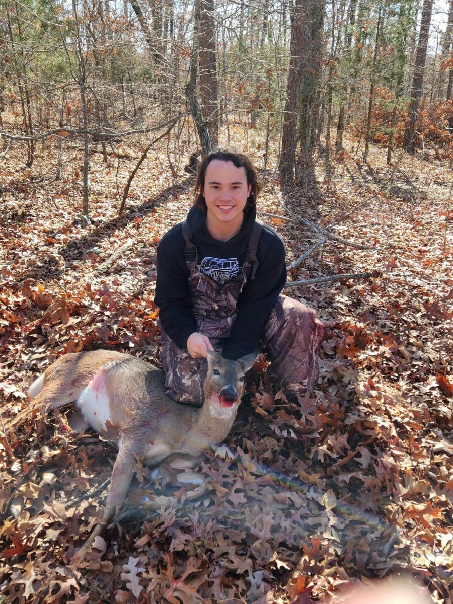 Reece Ahrens (12) poses with a deer during his hunting season. Hunting and fishing are not just hobbies, Ahrens said, theyre a way of life...” 