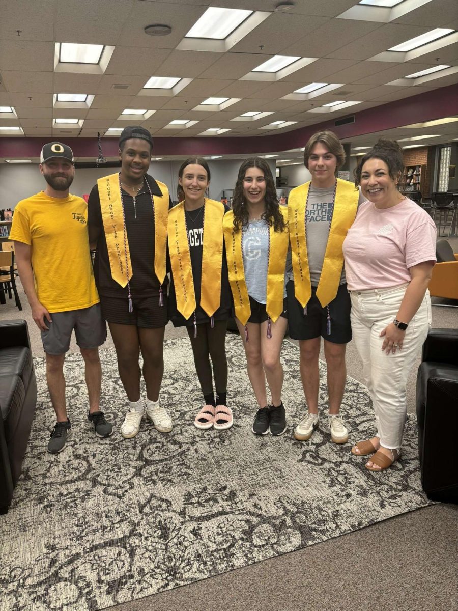 Brianna Nitz and Isaac Freitag pose with the Student Council executives during a ceremony held at the last meeting. I became a teacher not just to teach Spanish, but to create a space where students feel welcome, supported, creative, and ultimately to have fun while learning, she said. Nitz was a Student Council advisor, but she also spearheaded the creation of Games Club. 