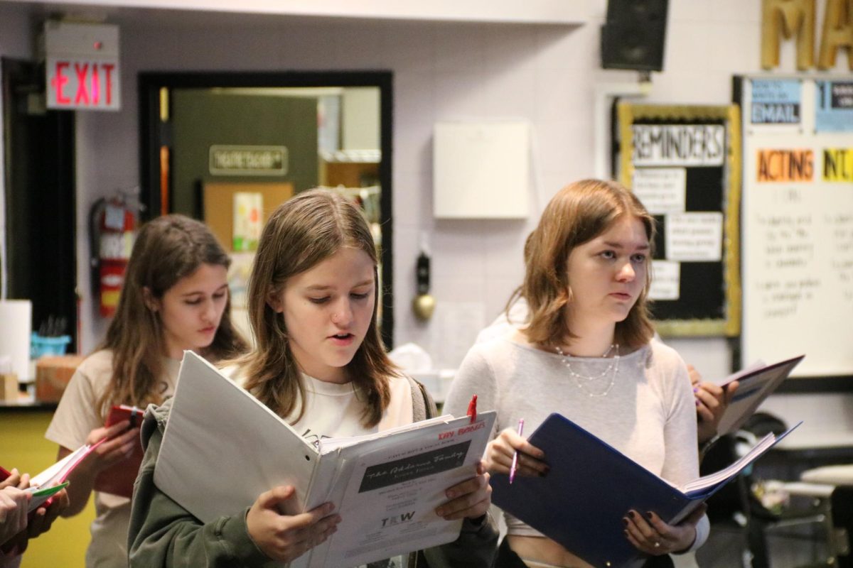 Cast members get together to rehearse singing their parts of "The Addams Family" musical. “Our first rehearsal, the cast sounded amazing together, and I think the show will be a lot better than last year,”  Teagan Crecelius (11) said. Not only are they trying to keep their reputation, the cast is hoping for an even better performance this year.