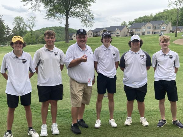 Coach Rodney Gerdes stands with the golf team at state. "[I coach and teach at OHS because] there were teacher openings. It came with the fact there were a bunch of coaching positions...I said 'I'll coach anything' to get a job as a teacher," Gerdes said. He has been coaching and teaching since he got out of college over 20 years ago. 