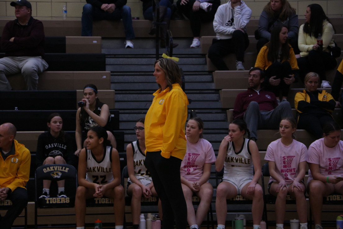 Laura Bishop stands watching her players on Senior night. "At the end of last school year I just finished my 25th year of basketball coaching and 14th for track," Bishop said. She had played both sports when she was younger and made it to state for track.