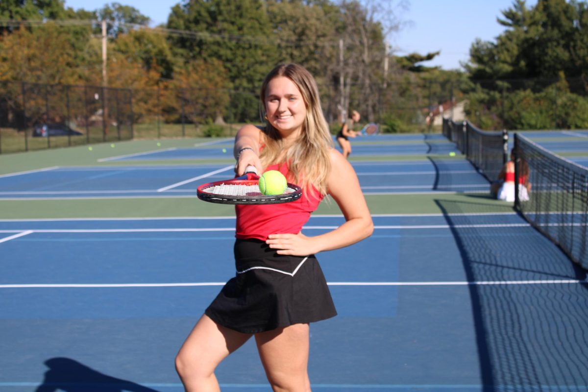 Senior Michelle Gruden poses for  a photo on the tennis court. Gruden has been a top tennis for OHS team since her freshman year. “Tennis has been a big part of my life," Gruden said. "I’ve learned so much from so many people, and I can’t wait to continue in college.”  
