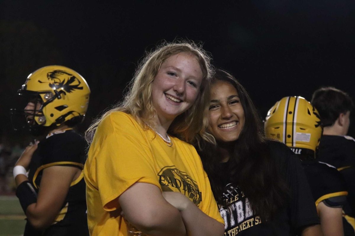 Haley Hughes(11) and Alayna Dickerson (12) pose for a photo on the sideline. "I kind of just play off their vibes,.There are some of the players that will get hype, and I will get hype with them and then we will try to get the rest of the team hype," Dickerson said. Both of them are looking into a career related to sports in the future.