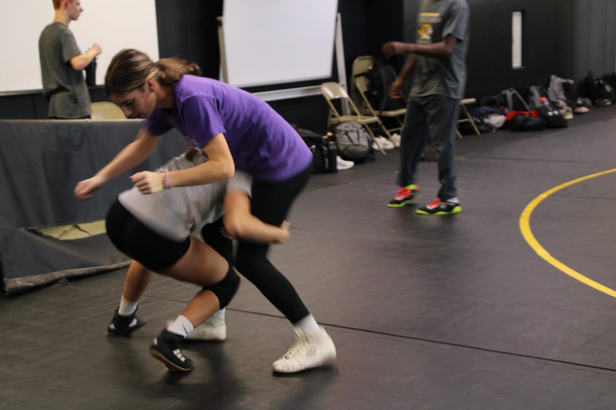 Jenna Voyles (12) practices taking shots during wrestling practice on Nov. 19. “Wrestling is more of one person sport, like it’s you against someone else,” Voyles said. Voyles joined the wrestling team her sophomore year. 