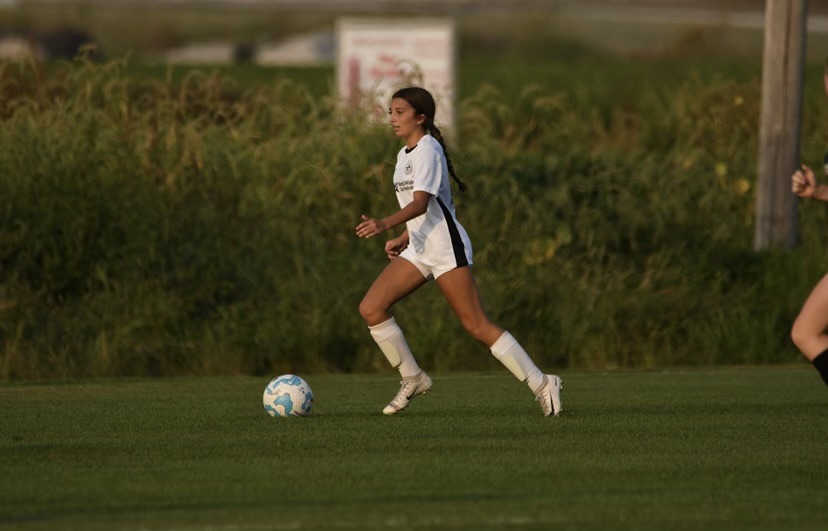 Emiley Callison (9) dribbles the ball up the side. “The position I play is wing defense, so I always have the opportunity to take the ball up the side of the field and make a pass,” Callison said. According to Callison, wing defense is a defensive position, but it can have an offense aspect to it as well in a game. 
