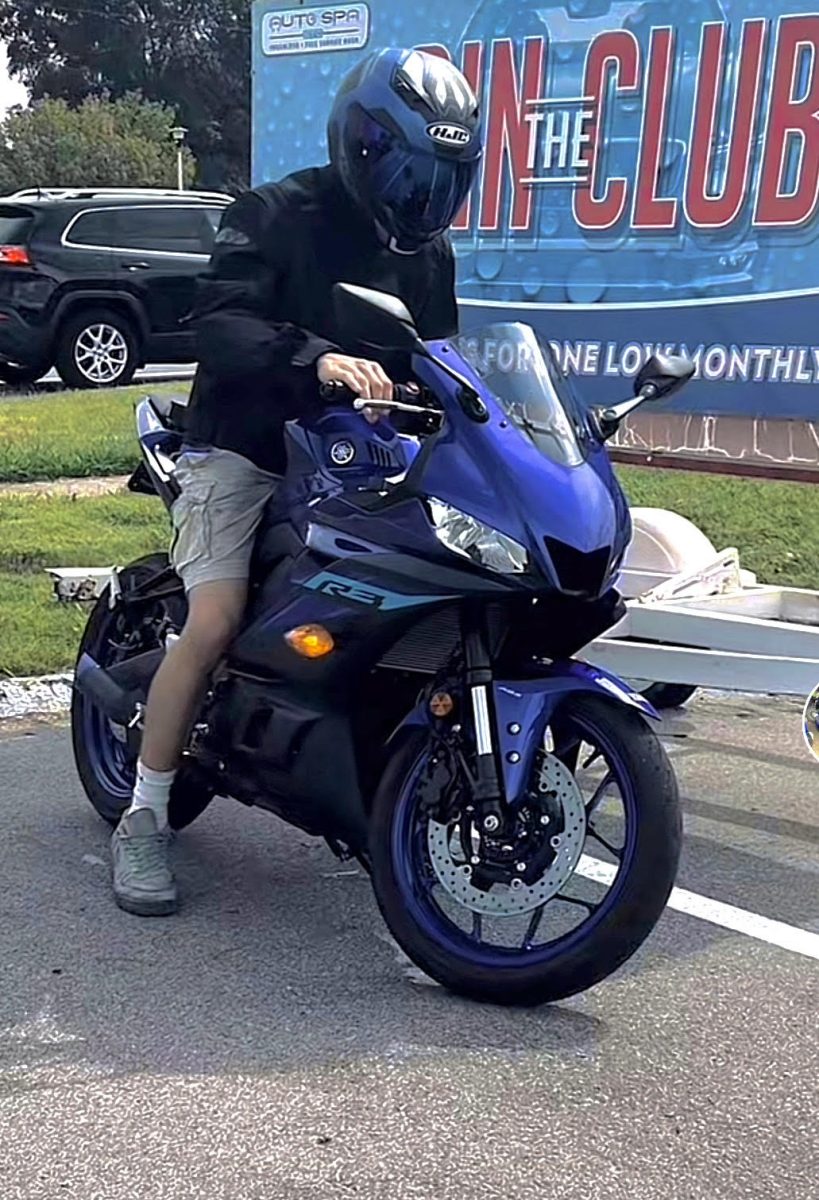 Ricky Nickles (12) sits on his motorcycle after work Oct. 28, 2024. “After work drives are always nice because it's usually warmer out,” Nickles said. Nickles liked to take his bike to work every day to get more riding time. 