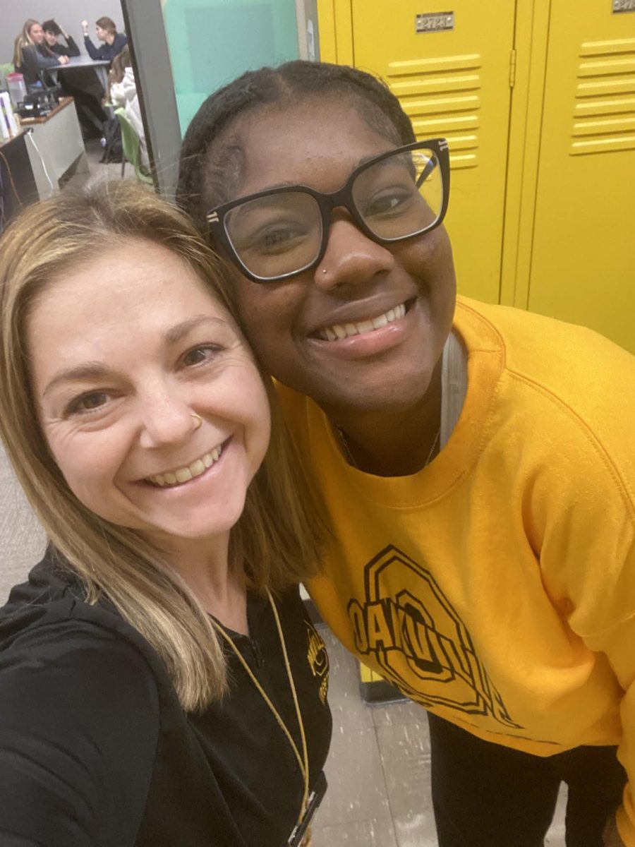 Paige Scott and Talia Reed (12) pose for a picture."...It's nice to have what feels like a team mom in the team again after not having one," said reed. Reed also mentioned that she enjoys the bond she is building with coach scott.