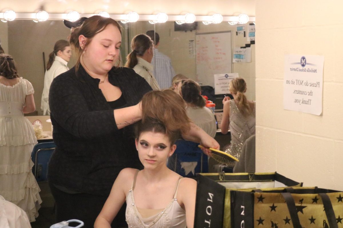 Danica Bettis (12) styles the cast’s hair for "The Addams Family" musical. “I did hair, wigs and the bald cap for Addams Family. It was such a tiring and fun experience all at once,” Bettis said. Bettis added she was grateful for her family and future which motivated her.