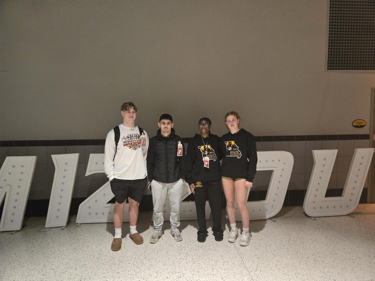 The four state qualifiers stand in front of Mizzou Tigers letters in Mizzou Arena on March 1. "I love competing, it’s my favorite thing to do," Kaden Updike (10) said. While they participated in the tournament, none of the wrestlers placed in the state tournament.