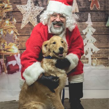 Traxler poses with a smiling puppy. 
