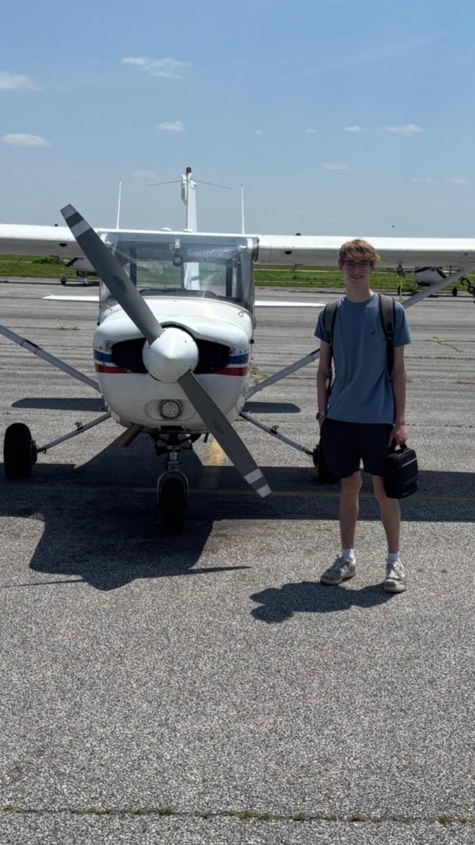 Ethan Black (11) stands in front of a plane he is about to fly over the summer. "Flying is freeing," Black said. This was the plane Black usually flies.