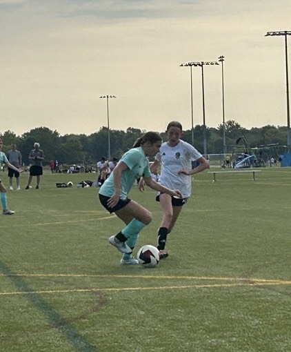 Peyton Kern (9) tries to steal the ball from the opposing team in her soccer game. “Soccer has taught me a lot of skills both physically and mentally throughout my life,” Kern said. Kern added that even though soccer takes up a lot of her time and focus, she still loves the sport.
 