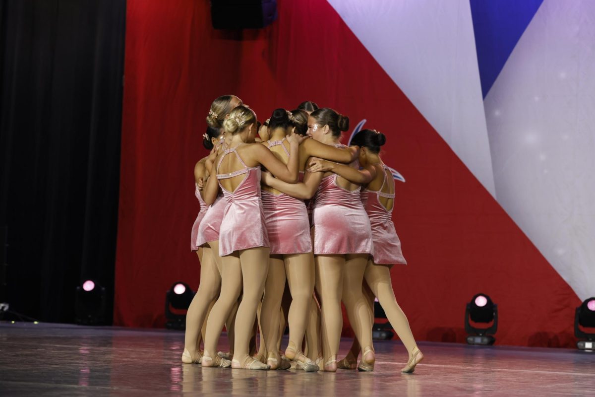 The Golden Girls hug after preforming during Nationals. "I'm just excited to be able to hang out with my team, and make new memories," Lily Nyguen (11) said. 