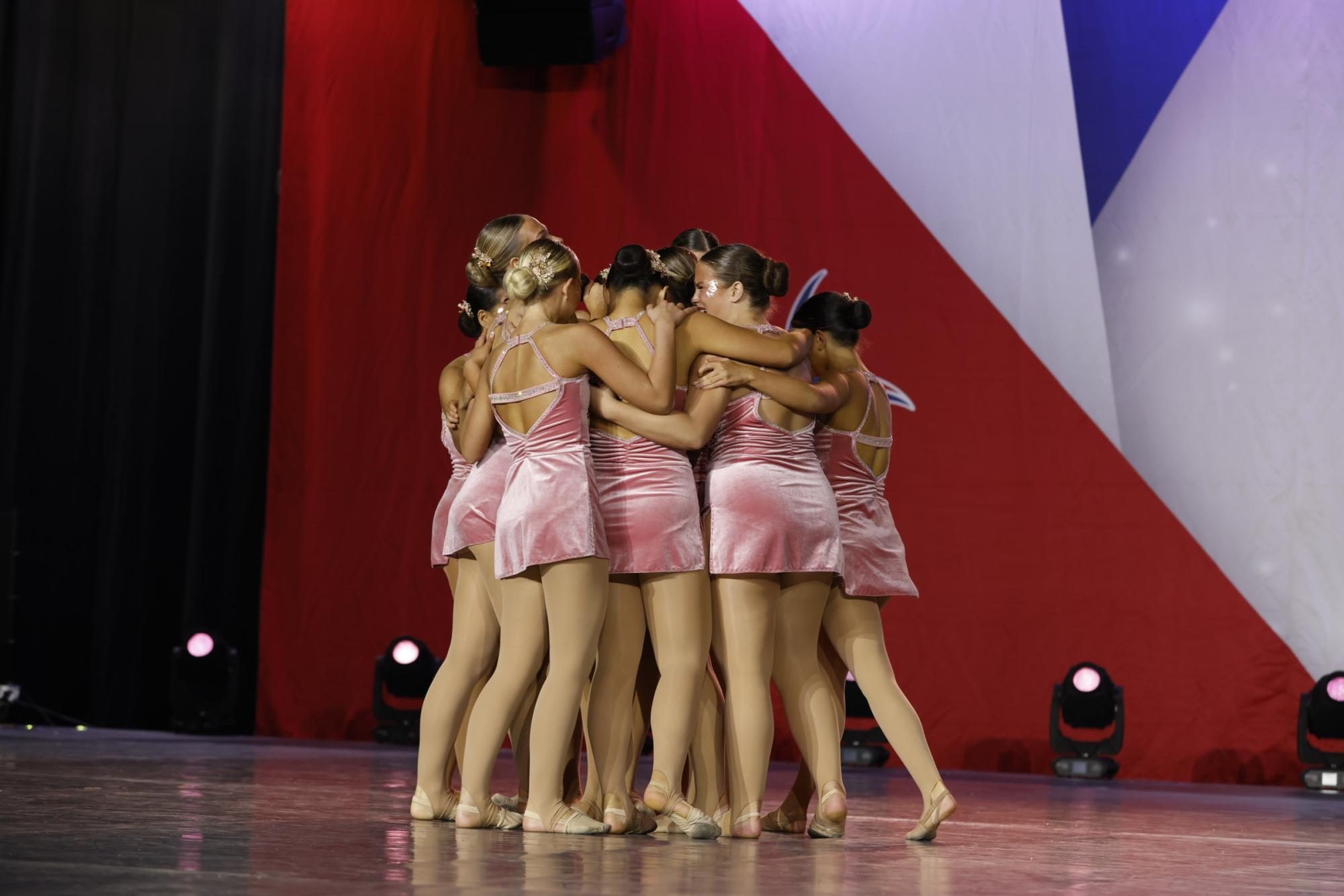 The Golden Girls hug after preforming during Nationals. "I'm just excited to be able to hang out with my team, and make new memories," Lily Nyguen (11) said. 