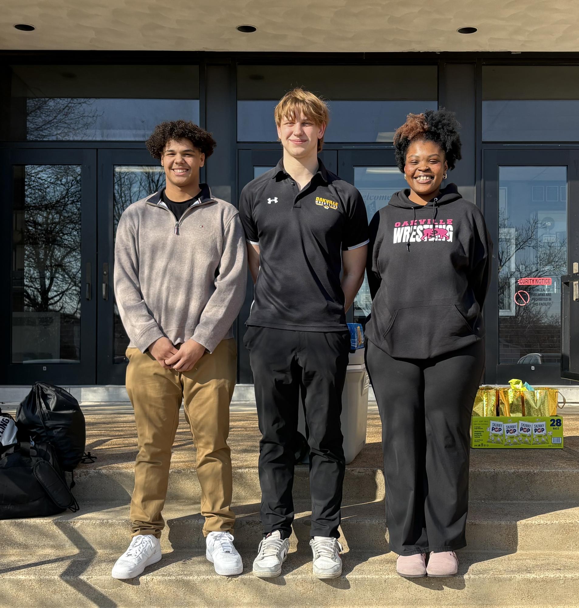 Isaiah Scullin (12), Kaden Updike (11) and Zamya Woods-Johnson (12) pose for a photo before leaving for state. "I just really focused on practicing," Scullin said, "and I just went to every practice with a mindset of 'I'm here and now it's time to put in more work and just achieve more goals.'" While Scullin and Woods-Johnson did not place, Updike placed sixth.
