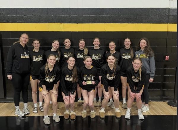 The girls varsity basketball team pose for a photo. "Even though this season had its struggles, we all still had fun and I felt that our bond got stronger throughout this season," Delaney Earney (12) said. The girls varsity team had a winning record of 14-12.