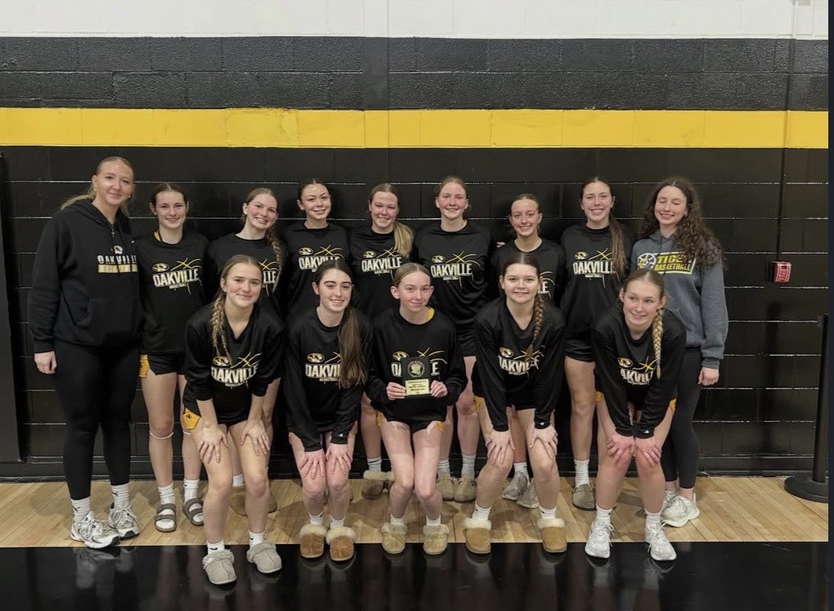 The girls varsity basketball team pose for a photo. "Even though this season had its struggles, we all still had fun and I felt that our bond got stronger throughout this season," Delaney Earney (12) said. The girls varsity team had a winning record of 14-12.